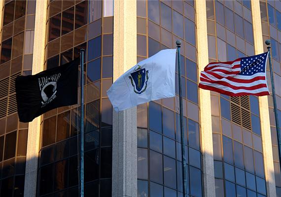 The John W. McCormack Building (One Ashburton Place, Boston), with the American Flag, Massachusetts flag, and POW-MIA flag in the foreground